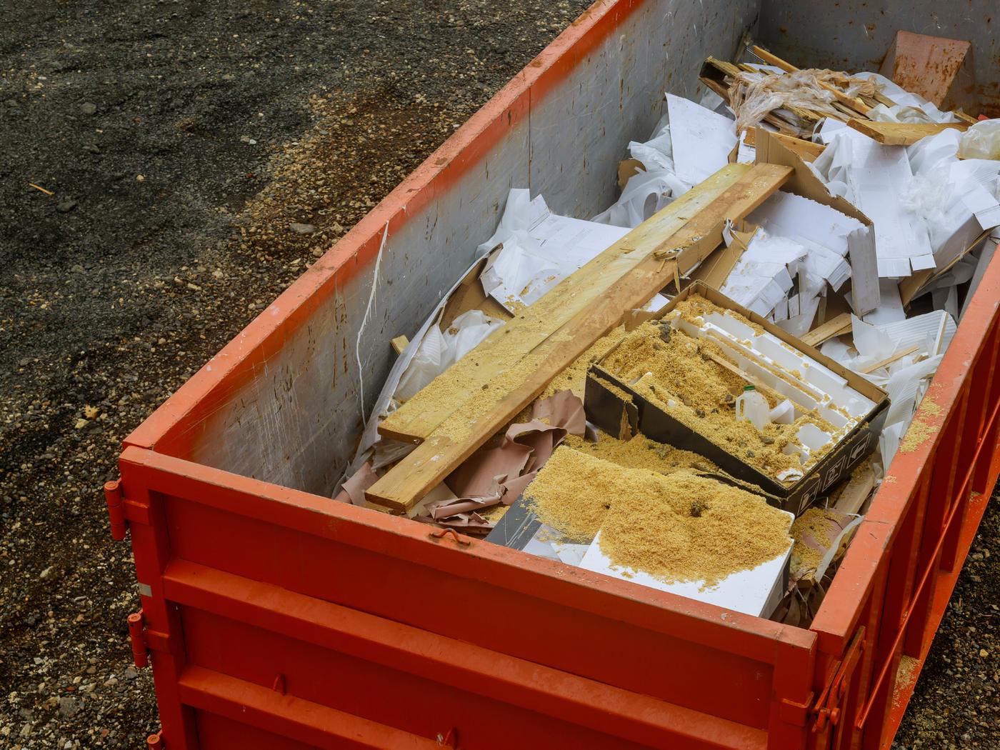 Lumber, drywall scraps and packaging in a debris container