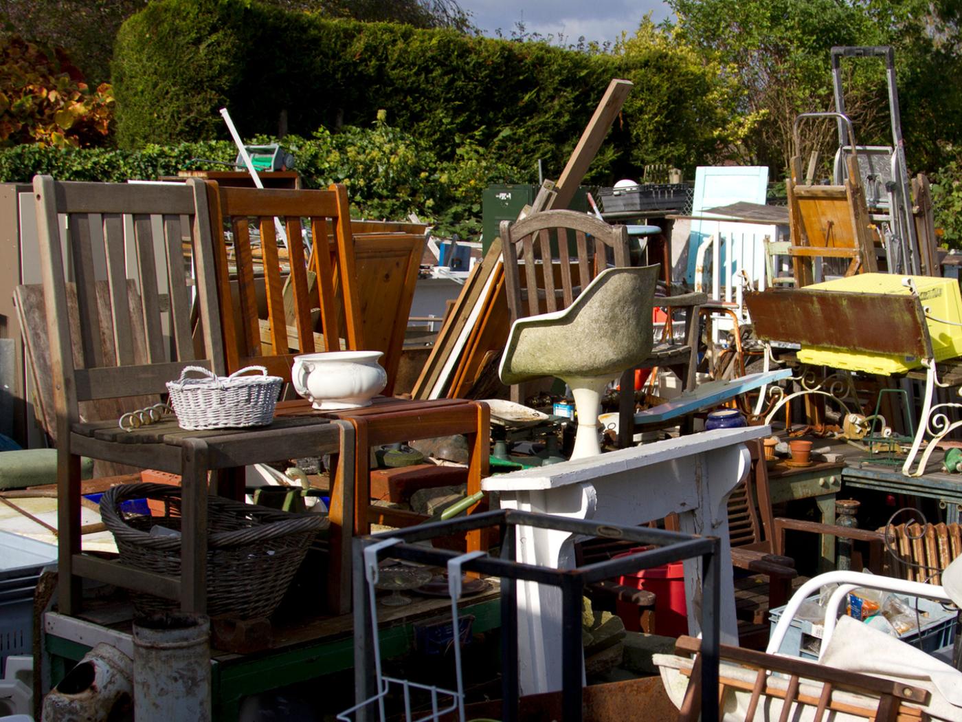Furniture and household items gathered outdoors during a full-property cleanout